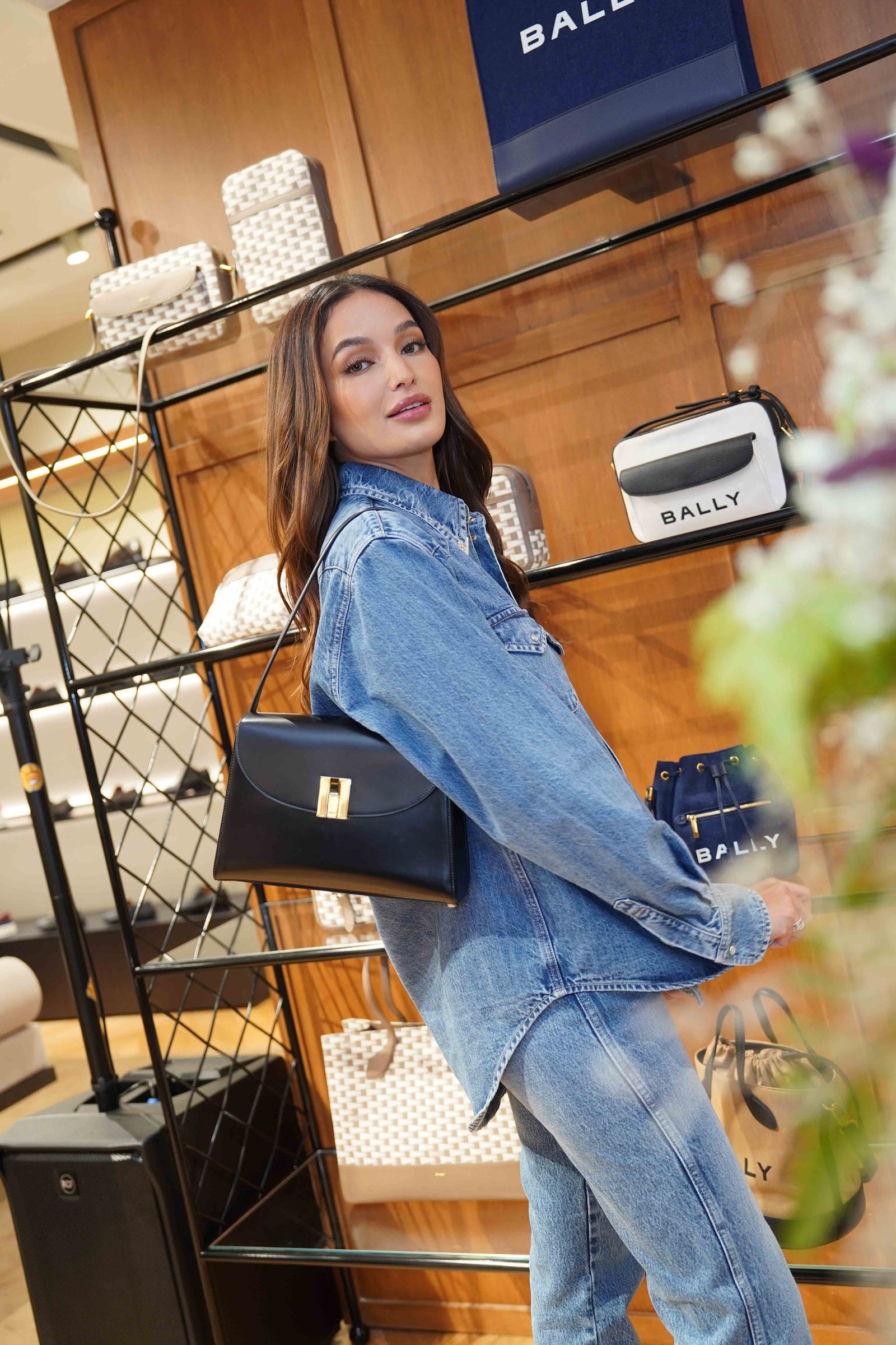 Sarah Lahbati with the Bally Ollam Shoulder Bag in Black Brushed Leather.